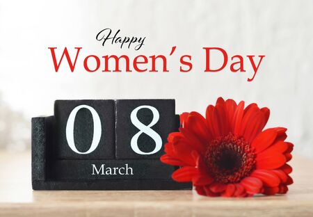 Happy International Womens Day card. Wooden calendar and red gerbera flowerの写真素材