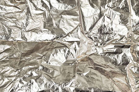 Shiny crumpled aluminium foil texture background. Shiny silver surfaceの写真素材