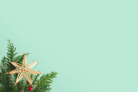 Christmas card or background with straw ornament, fir branches and copy spaceの写真素材