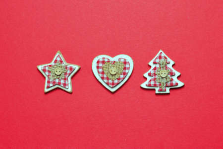 Wooden Christmas decoration on red paper background
