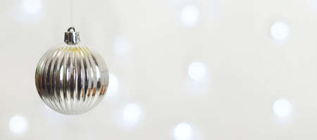 Christmas bauble on background with blurred lights and copy space