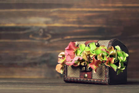 Autumn flower decoration. Hydrangea flower in wooden trunk