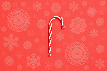 Christmas candy cane on red backgroundの写真素材