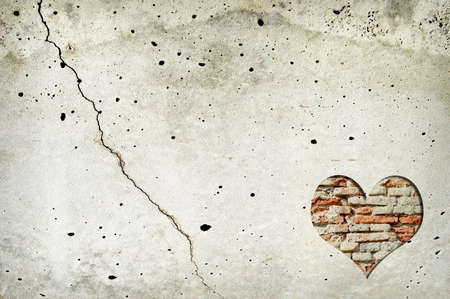 Heart shape made of old bricks on concrete wall. Valentines day background with heart shape and copy spaceの写真素材