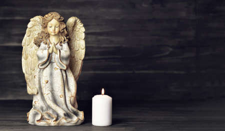 Condolence card with an angel and a burning candleの写真素材