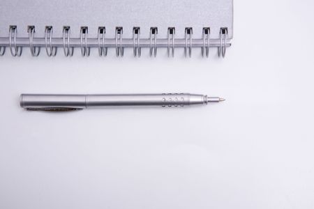 aspiral notebook and pen on the white backgroundの写真素材
