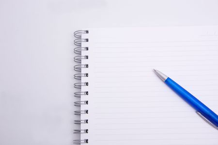 aspiral notebook and pen on the white backgroundの写真素材