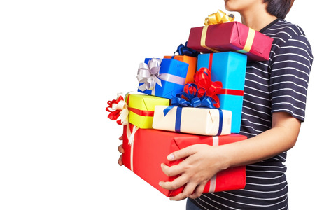Asian female holding a lot of Christmas gifts in her handsの写真素材