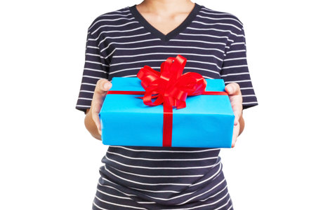 Asian woman holding a gift box in a gesture of giving.