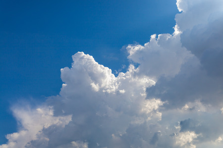 a big and fluffy cumulonimbus cloud in the blue skyの写真素材
