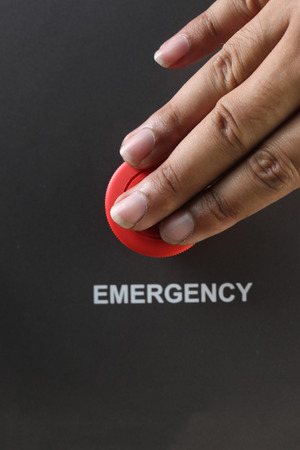Asian Male hand pushing emergency red button.の写真素材