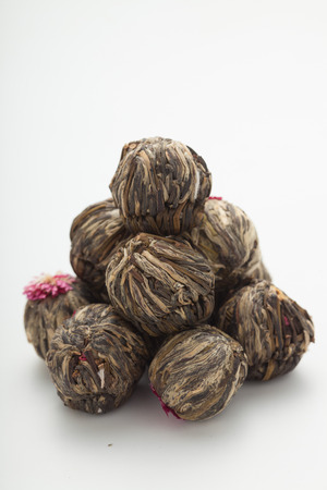 Aromatic flower green tea ball/ blooming tea on white backgroundの写真素材