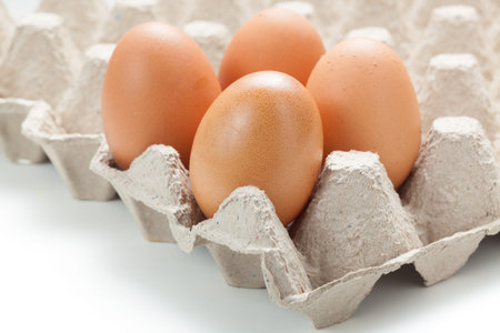 Close up of  eggs on egg rag. Egg cartons packing. on white background