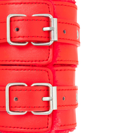 Close up of buckle belts on a BDSM leather red handcuffs. isolate on white background (with Clipping path and copy space)の写真素材