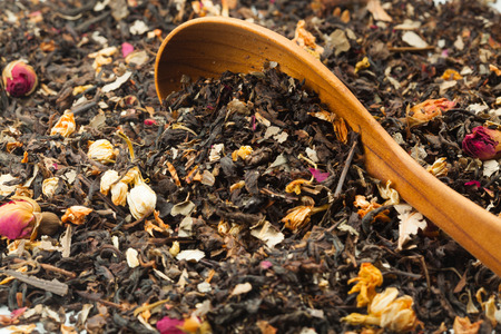 Dried flowers tea leaves with wooden Spoon. Selective focus on blurry background.の写真素材