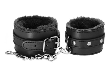 Pair of a black color leather handcuffs isolate on white background with clipping path.の写真素材