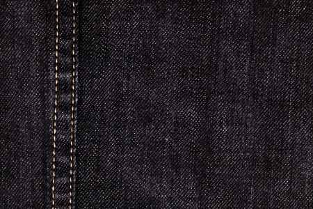 close up of black denim and stiches jeans texture for graphic designの写真素材
