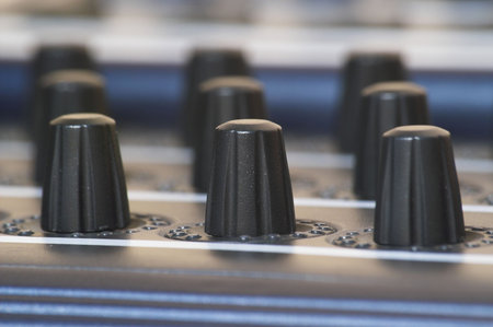 Three rows of midi controller knobs. Shallow depth of field (DOF)の写真素材
