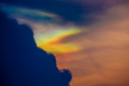 Black clouds with colorful clouds and sunlight in the evening.の写真素材