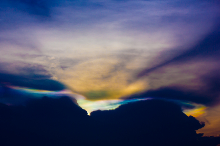 Black clouds with colorful clouds and sunlight in the evening.の写真素材