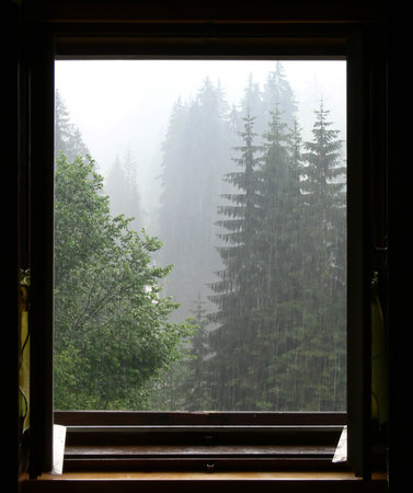 View out of the window on rainy mountain landscape
