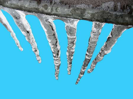 Icicles isolated against blue background