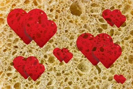 Red hearts on sponge texture
