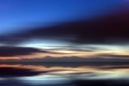 Abstract landscape with the sea and clouds in motion at duskの写真素材