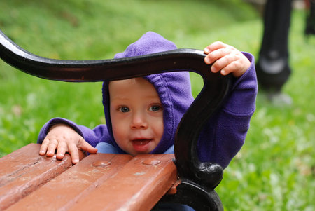 Happy toddler playing in the park in autumnの写真素材
