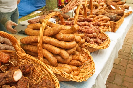 Traditional meet on a stall in a market の写真素材