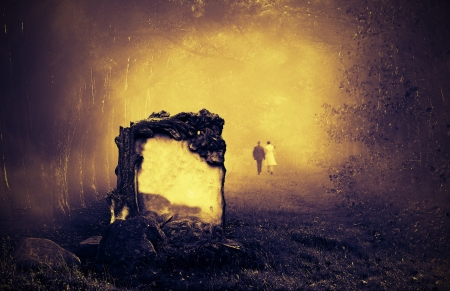 Wedding couple walking away from a grave in a forestの写真素材