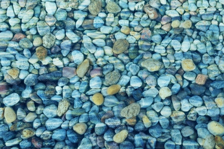 Colorful pebbles under water surfaceの写真素材