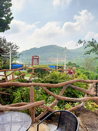 wooden fence and terrace with view of mountain and sky.の写真素材