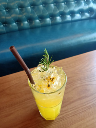 Cocktail with ice and rosemary in a glass on the tableの写真素材