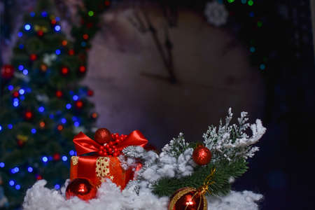Christmas gift with Christmas toys on the background of lights, Christmas tree and big clockの写真素材