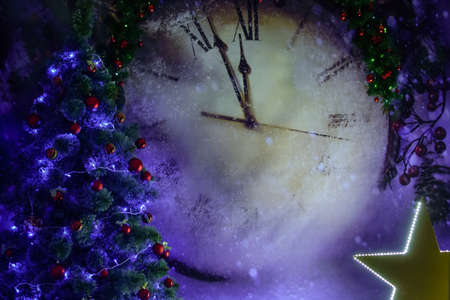 Large Christmas clock with a Christmas tree with toys and a large luminous starの写真素材