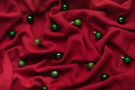Christmas backgrounds of red fabric with folds with Christmas balls