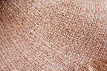 Traditional handicraft fabric, background texture of woven surface of strawの写真素材