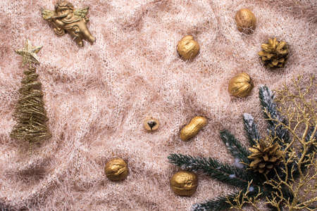 Christmas layout on a fabric background. New Years attributes. Christmas tree branches, golden nuts, spruce branch, golden tree.の写真素材