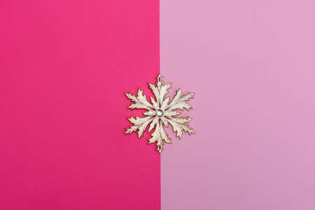 Christmas snowflake in the center close-up on a pink background.の写真素材