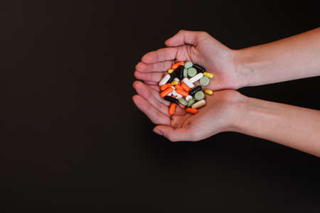 Colored painkillers capsules and tablets on the palm.の写真素材