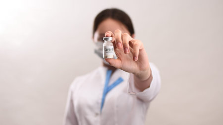 The coronavirus vaccine is in the hands of a female health worker. Development of the Covid-19...