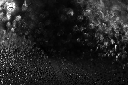 Black water drops background. Water drops on a car glass background. Water drops on car glass black bokeh background.の写真素材