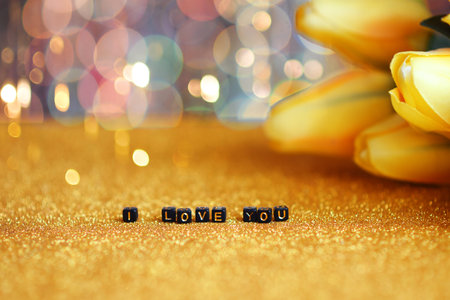 The concept of a declaration of love. I love you, the inscription is laid out in letters on a gold...
