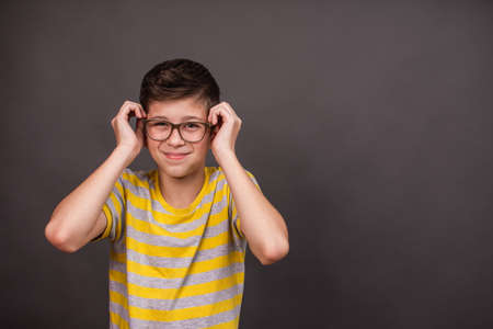 Upset unhappy boy with glasses has headache,の写真素材