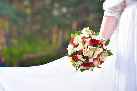Wedding bouquet in the hands of the bride. A fat bride holds flowers.の写真素材