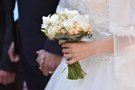 Wedding bouquet in the hands of the bride in close-up.