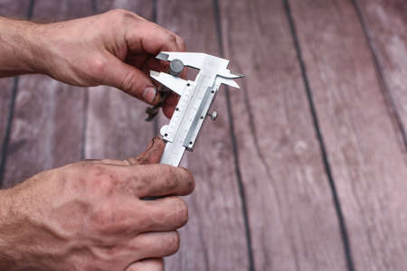 Measuring the drill diameter with a caliper.の写真素材