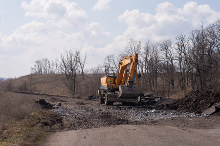 Excavator at the road construction out of city