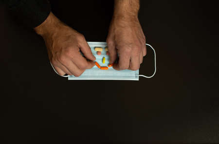 a smile on a medical mask made of pills.の写真素材